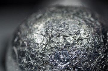 Unusual abstract techno view of crumpled aluminum foil ball, close-up, macro photography