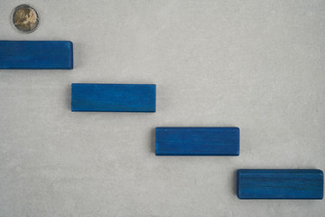 stairs made from blue bricks on top of concrete with two euro coin