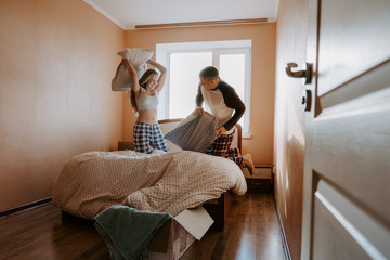 Isolating Together. Mother And Daughter Pillow Fight In Bed. Couple stay home. Family lockdown, how to emotionally prepare for coronavirus quarantine, self- isolation, Social Distancing