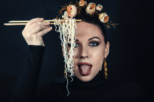 Beautiful girl eats noodles doshirak.
Studio photography, filter stylized photography