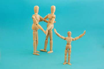 Concept - happy family and a child. Group of three wooden men on a blue background.