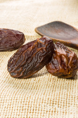 Big luxury dried date fruit on a linen napkin, kurma ramadan kareem concept, close up.