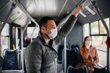 Passengers on public transport during the coronavirus pandemic keep their distance from each other....