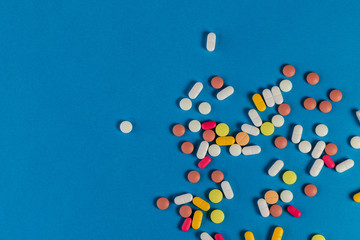 Different medicine pills, tablets on blue background. Many pills and tablets with space for text. Health care. Top view. Copy space. New image. Pharmaceutical picture. Nice flatlay. Background