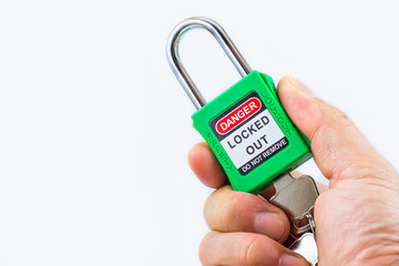 Hand holding green key lock and tag for process cut off electrical,the toggle tags number for...