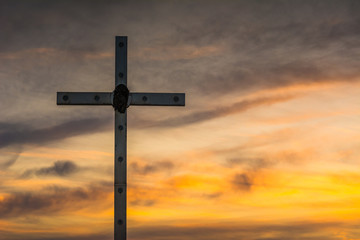 Cross silhouette with the sunset as background