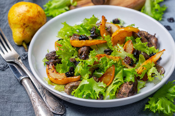 Salad with fried chicken liver and pears.