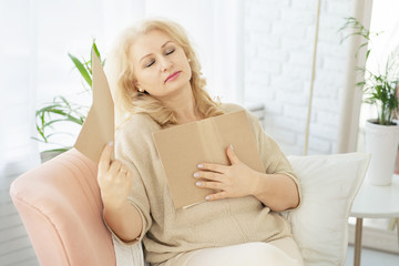 A middle-aged woman woman feels bad because of menopause. She needs support. Hot flashes, sweating, dizziness, irritability. Menopause concept. Harmonious restructuring of the body.