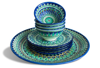 Set of national Uzbek dishes: a large dish and plates close-up isolated on a white background.