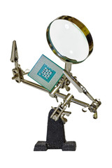 Humanlike clamp with loupe looking upon computer processor isolated on white