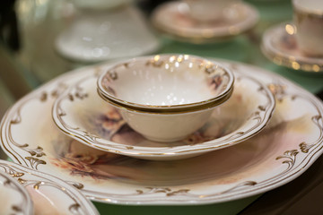 Little cup inside a small plate on a bigger plate