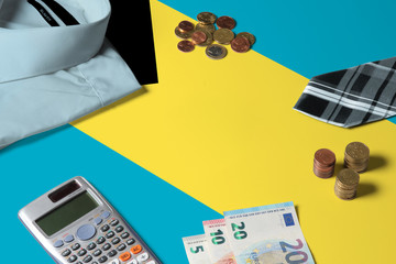 Bahamas flag on minimal money concept table. Coins and financial objects on flag surface. National economy theme.