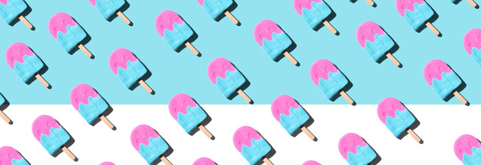 Pink and blue popsicles with shadow - overhead view