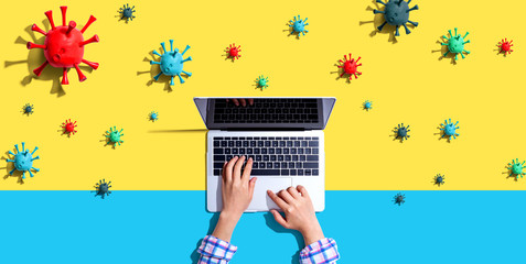 Laptop computer with epidemic influenza concept - overhead view