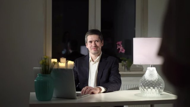 Man working in home office, woman seducting and undressing in lingerie
