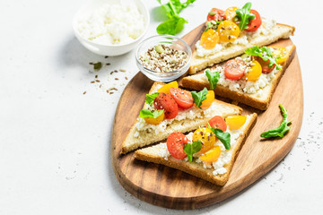 Cherry tomatoes goat cheese sandwiches. Selective focus, copy space.