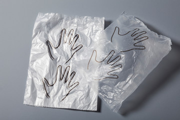 Disposable plastic protective gloves on gray background, close up shot, Prevention of infection...
