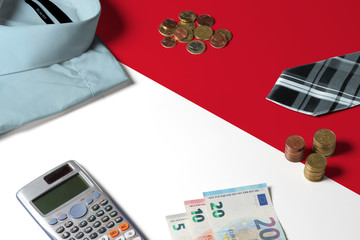 Indonesia flag on minimal money concept table. Coins and financial objects on flag surface. National economy theme.