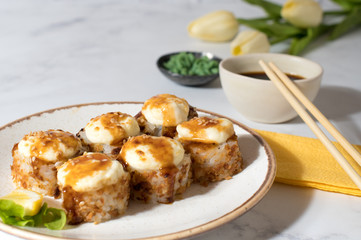 Close view on the plate of baked rolls with sauce