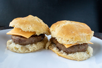 two homemade breakfast sausage biscuits on plate