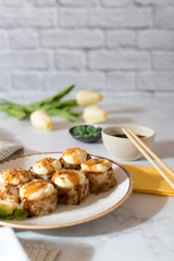 Close view on the plate of baked rolls with sauce