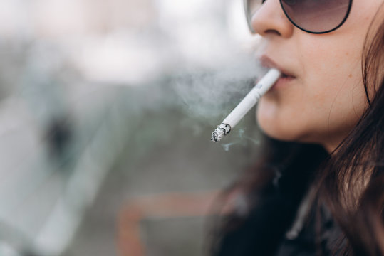close up portrait of girl smoking cigarette