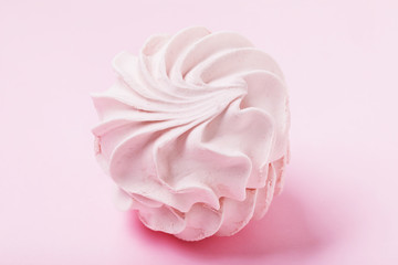 Marshmallow with cranberries on a pink background, close-up