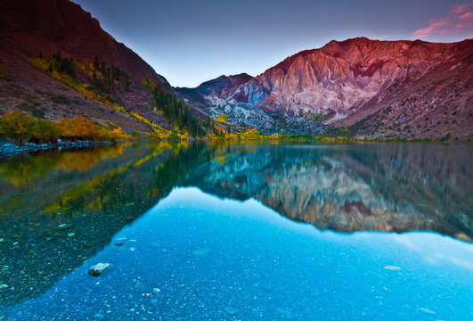 Sunrise Reflection of Laurel Mountain and Sevehah Cliff Surrounded by Fall Color on Convict Lake, Mammoth Lakes, California, USA © Billy McDonald