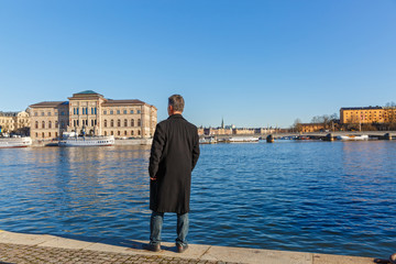 Stockholm, a man looks at the architecture of the city