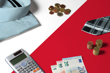 Malta flag on minimal money concept table. Coins and financial objects on flag surface. National economy theme.