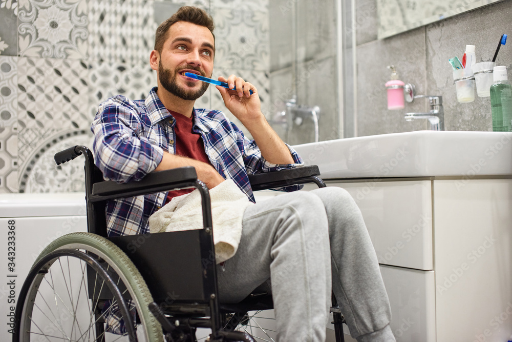 Wall mural handicapped man brushing teeth at home bathroom