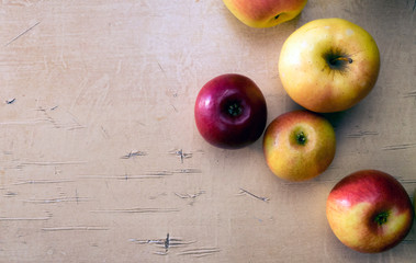 Background with fresh apples that lie on the table.