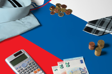 Slovenia flag on minimal money concept table. Coins and financial objects on flag surface. National economy theme.