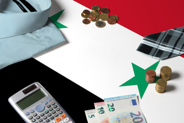Syria flag on minimal money concept table. Coins and financial objects on flag surface. National...