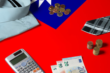 Taiwan flag on minimal money concept table. Coins and financial objects on flag surface. National economy theme.
