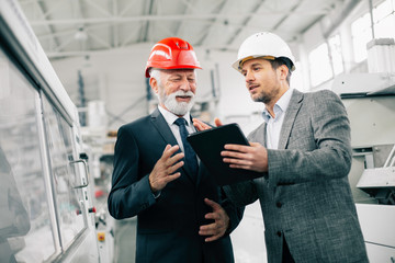 Colleagues working together. Arhitects in factory.	