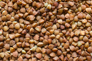 Buckwheat texture. Background with buckwheat. Brown buckwheat groats.