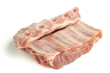 fresh raw pork ribs isolated on a white background. two pieces. ingredient for meat cuisine. side view