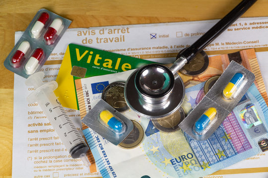 Medical work stop notice written in french language, vital card, black stethoscope, pack of pills and money