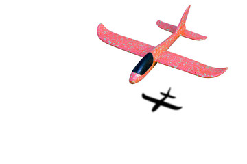 Children`s red airplane flies, isolate on a white background.
