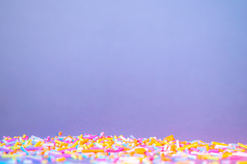 Cake decorating sweets, white background, baking colorful sprinkles, home baking decorations, copy spce for text, bright colors, pile of sweets, multicolored sweet pieces