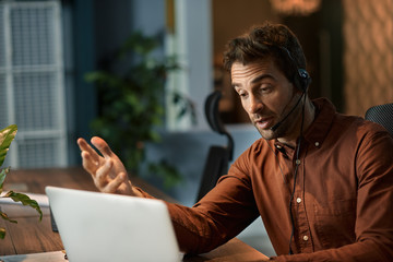 Businessman explaining something to a client over a headset