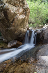 Fototapeta na wymiar Small waterfall between rocks in Sardinia