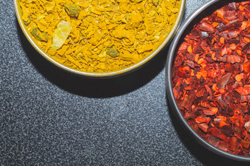 Dried chili pepper. curry spice. paprika and curcuma. red and yellow seasoning. condiment in the jars