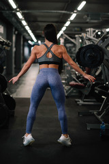 Fototapeta na wymiar Fitness woman on training. Young woman in the gym. 
