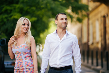 Fototapeta premium woman with her husband walking around the city, dressed neatly