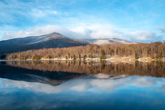 A bluebird morning view over a lake in the Adirondack Mountains. 