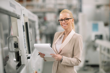 Factory manager in inspection of manufacturing. Woman in factory.	