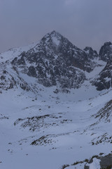 Clouds are touching the top of a mountain in a winter national park