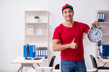 Young male courier delivering pizza to the office